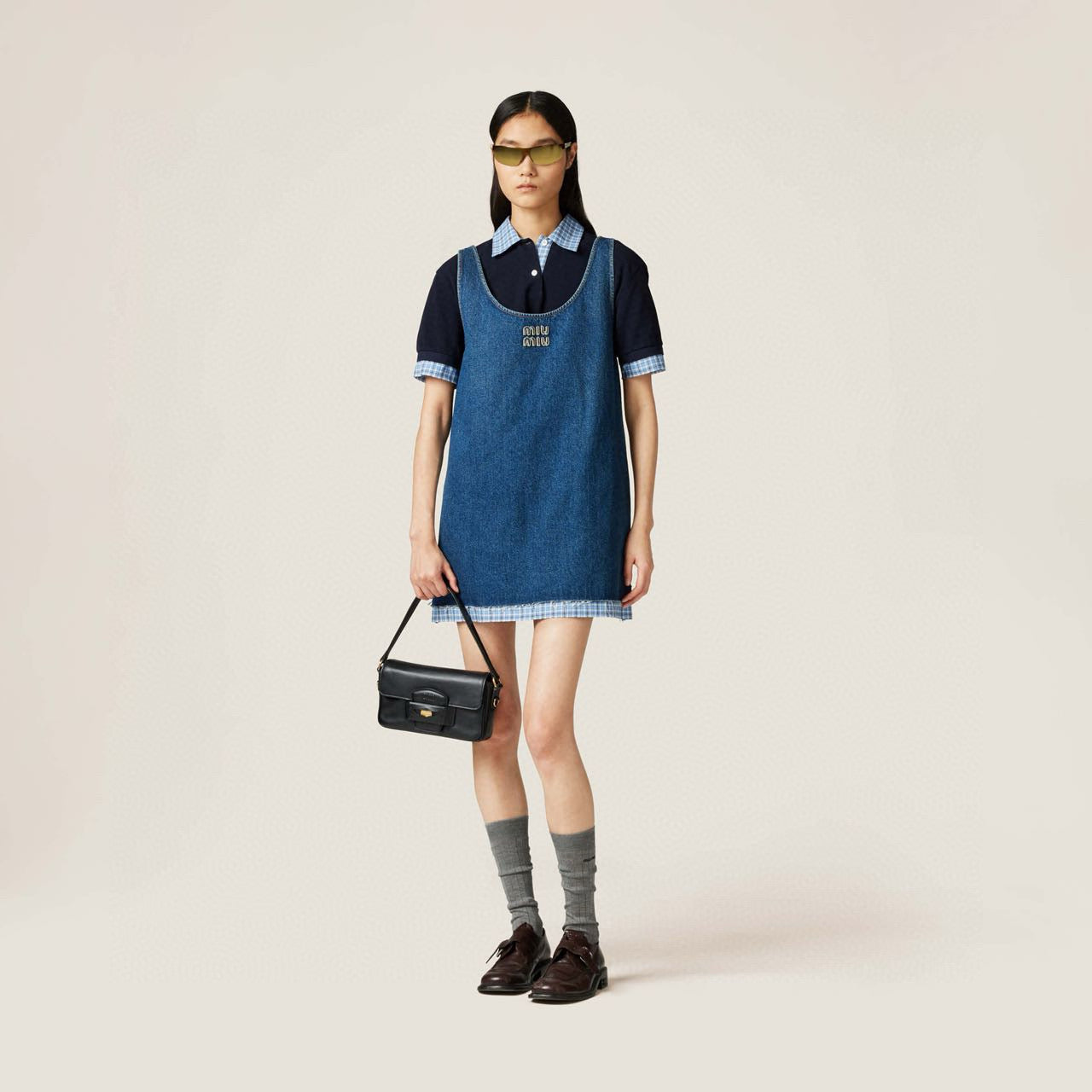 Embroidered denim skirt with raw edges and suspenders