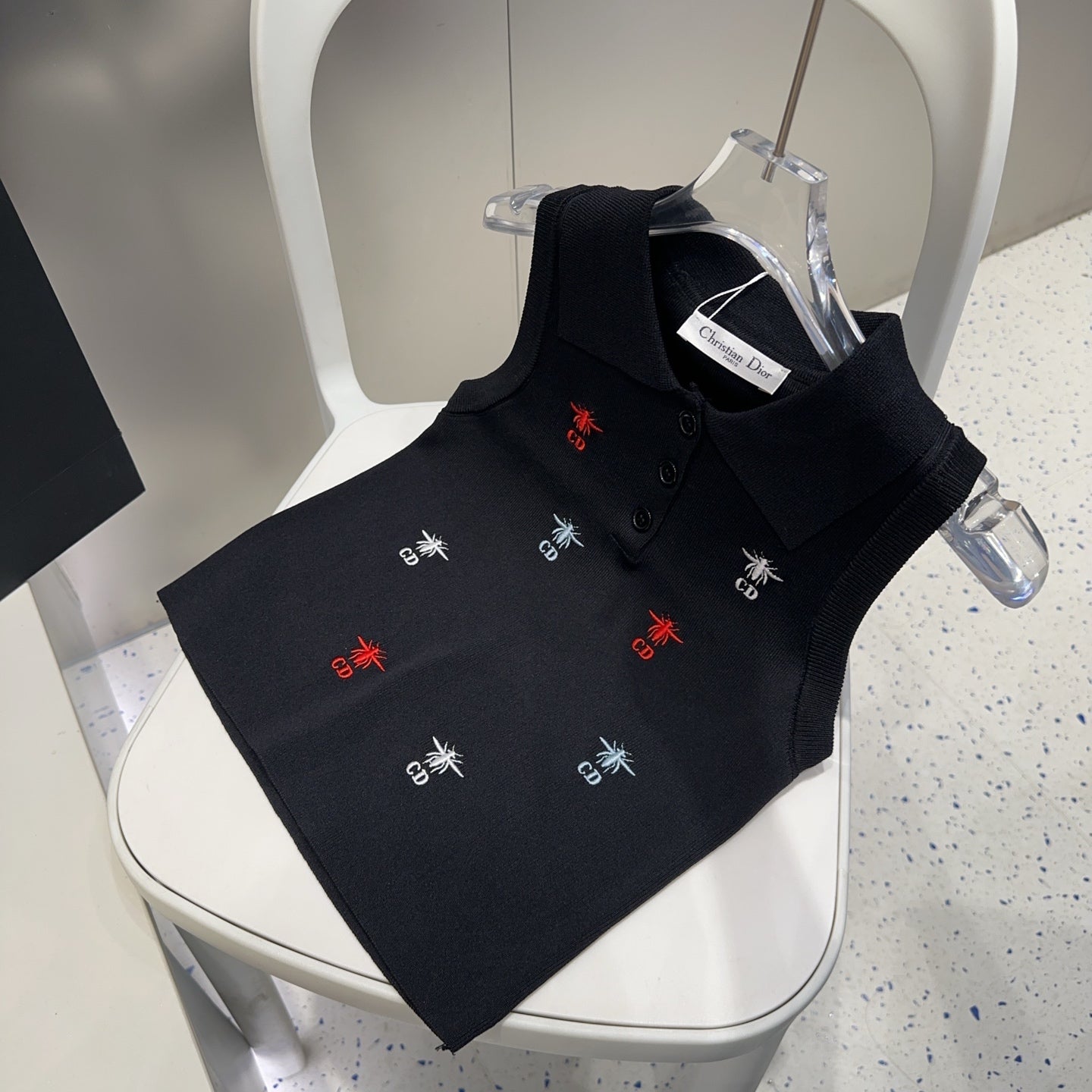 Small vest with a lapel logo print.