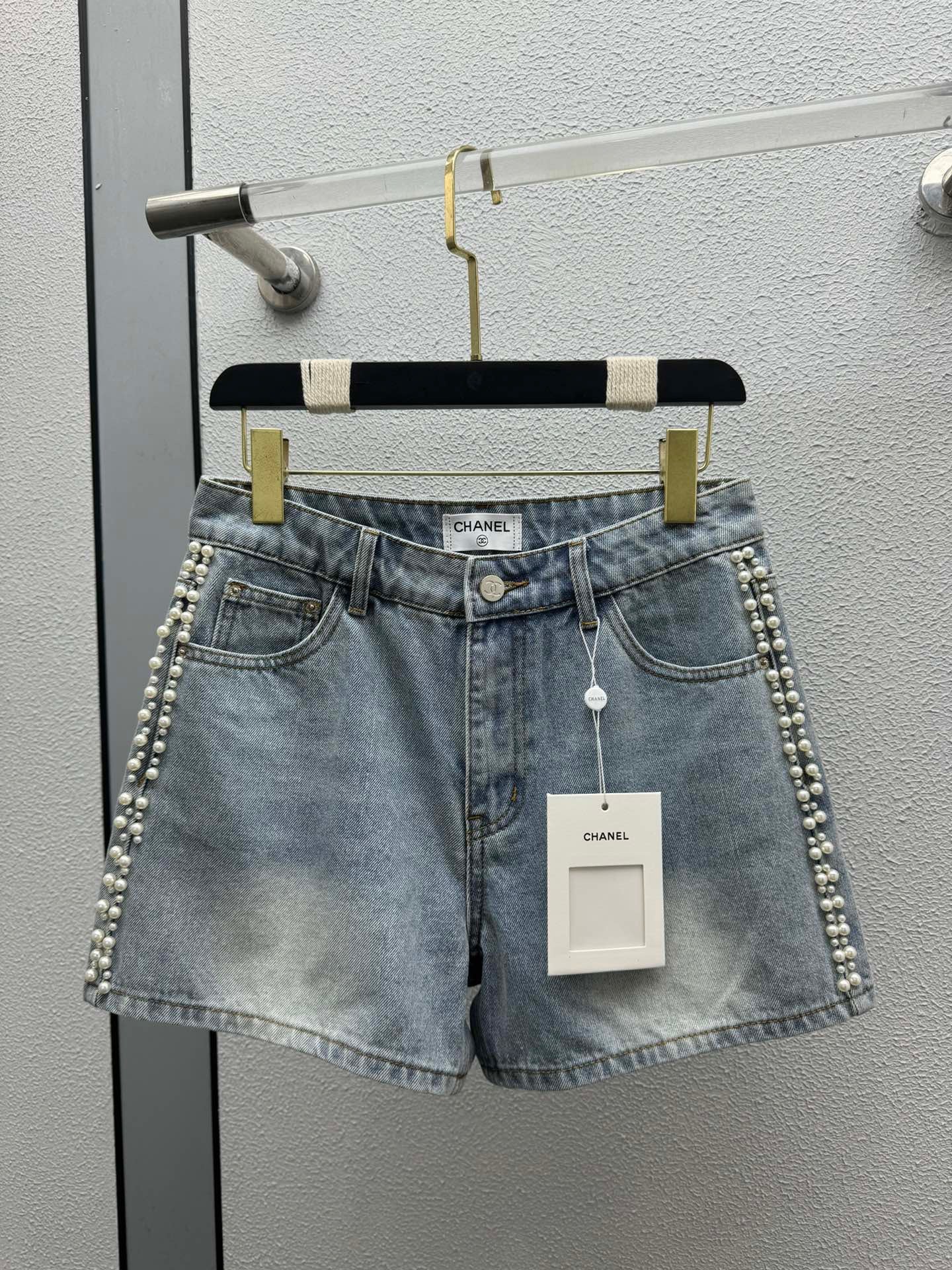 Denim shorts with pearl embellishments on both sides