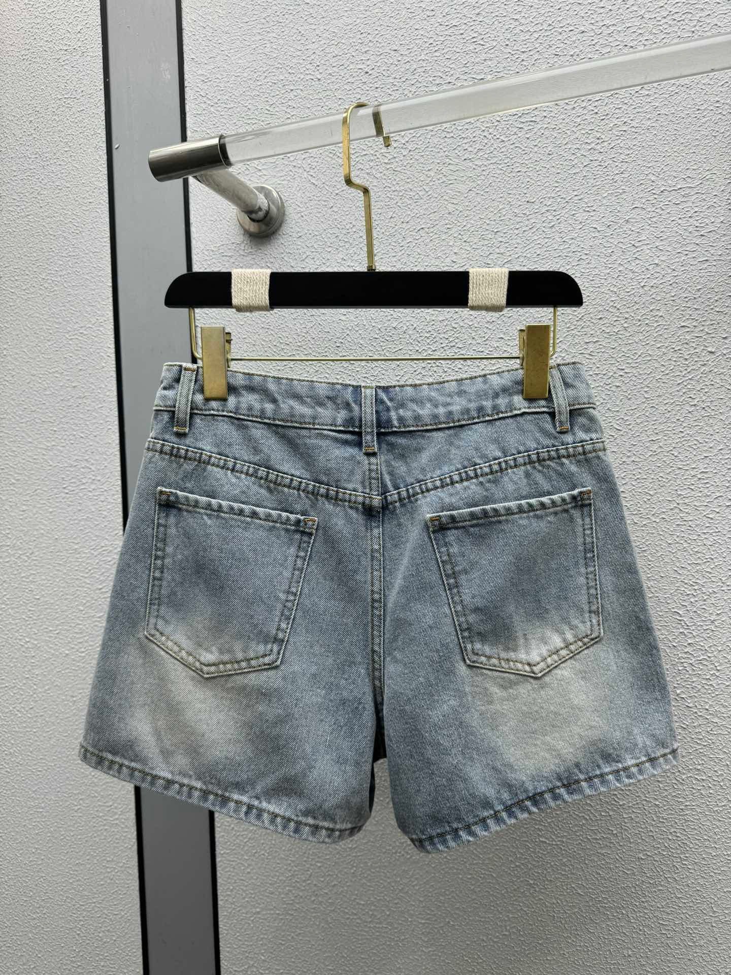 Denim shorts with pearl embellishments on both sides