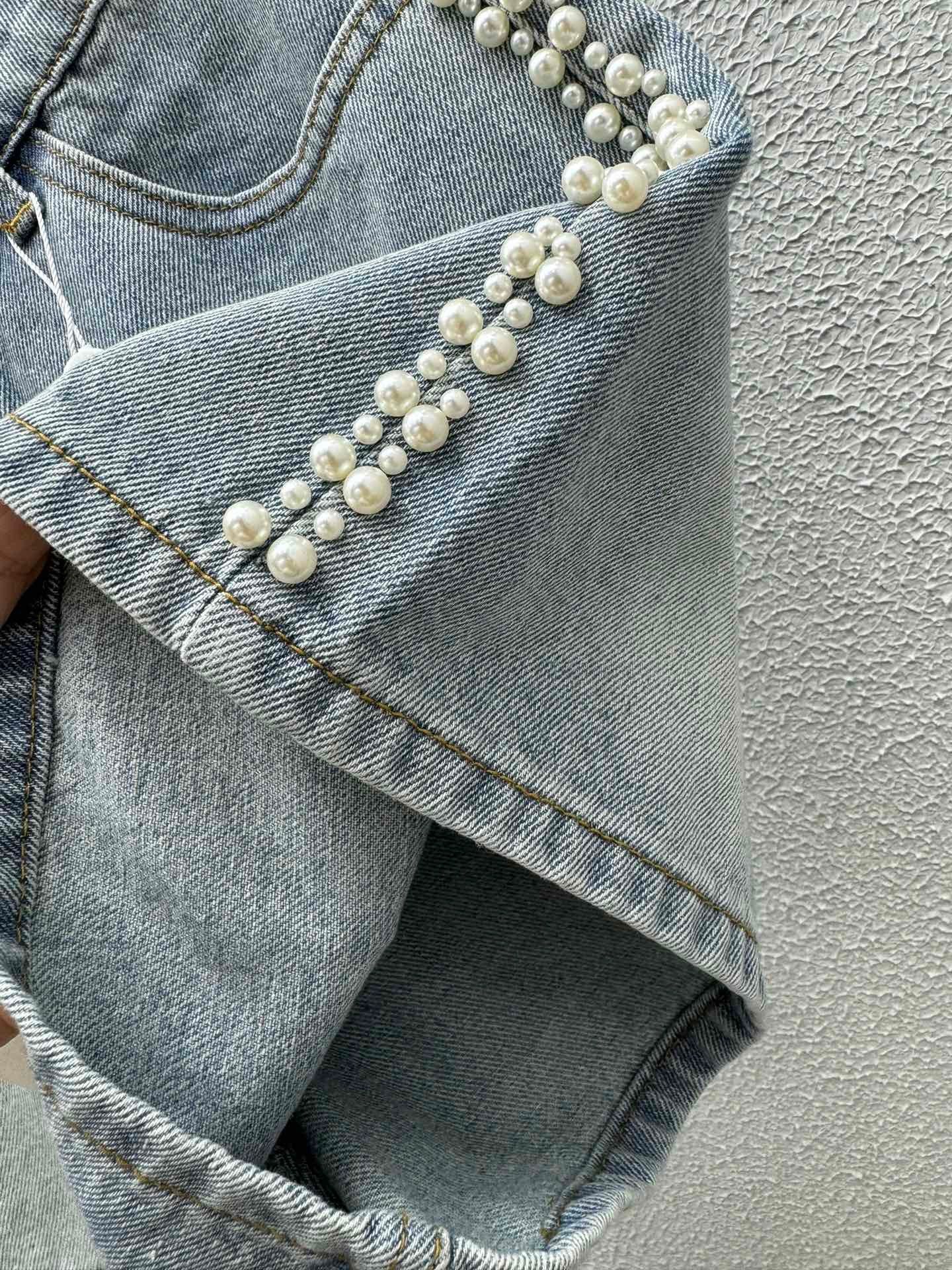 Denim shorts with pearl embellishments on both sides